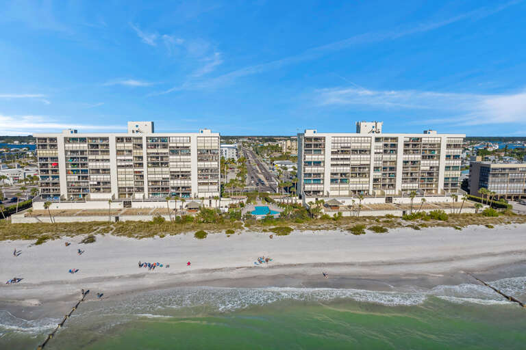 Beachfront complex offering direct access to pristine white sand and emerald waters, with pool facilities and coastal convenience.