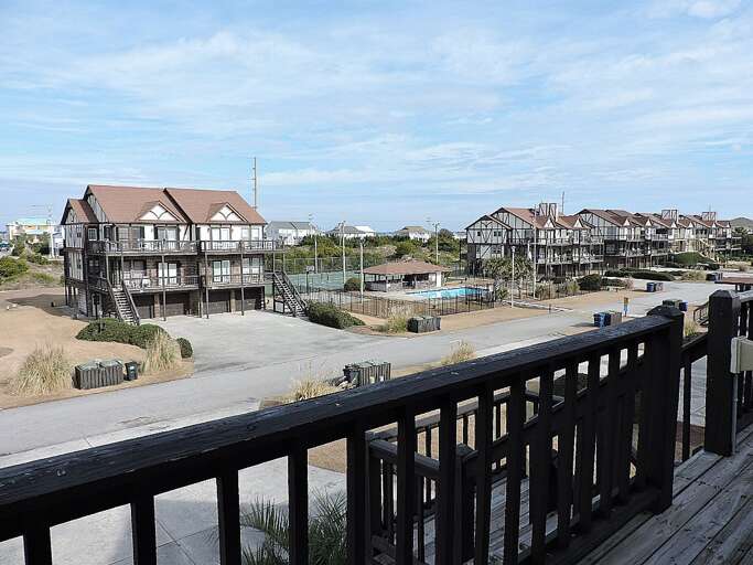 View of pool and tennis courts from deck  View of pool and tennis courts from deck