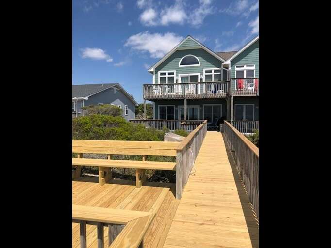 view of beach side of home from end of walkway view of beach side of home from end of walkway