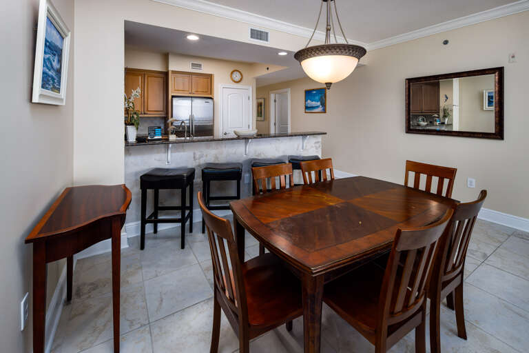 Contemporary dining table which has seats 6 and also features 4 more seats at the bar area to make room for all guests Contemporary dining table which has seats 6 and also features 4 more seats at the bar area to make room for all guests