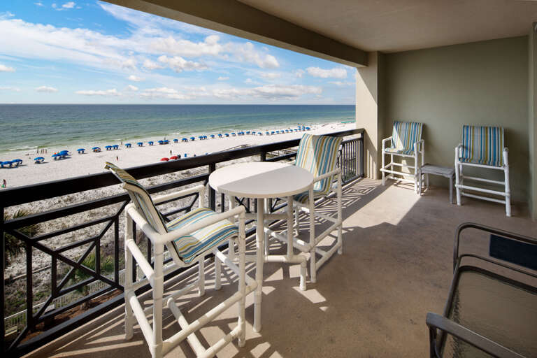 Bistro table and chairs, two lounge chairs, and a perfect view of the emerald waters