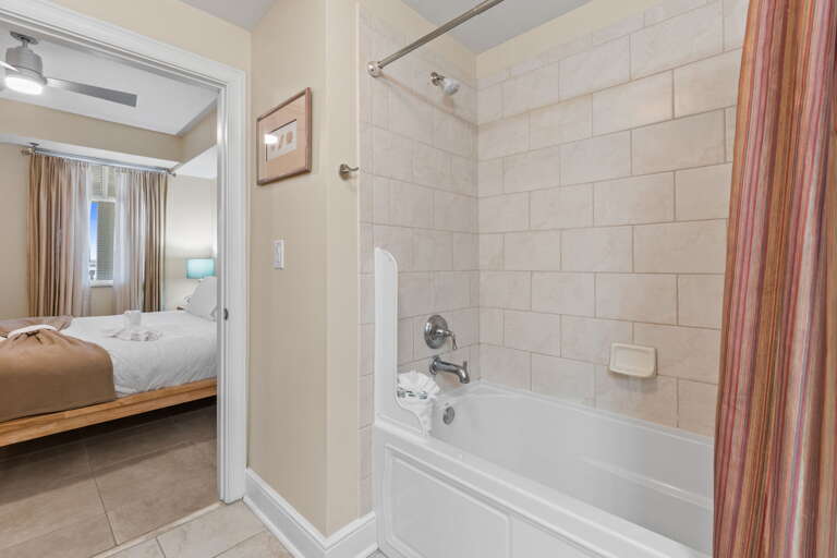 Spacious shower, tiled floors, and private entrance to the second guest bedroom
