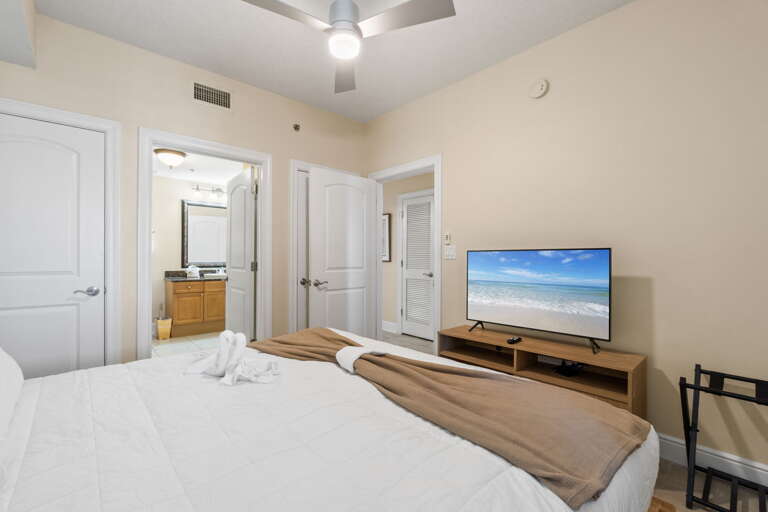 Inviting guest bedroom featuring a new king bed and private access to a shared bathroom for added convenience.