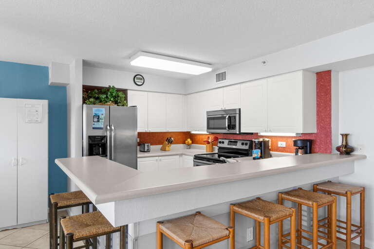 Kitchen with  stainless steel appliances and lots of storage space and extra seating at the breakfast bar.