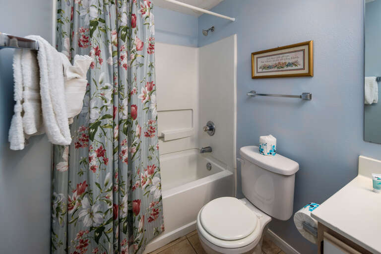 The guest bath is accessible from the hallway and the guest room.