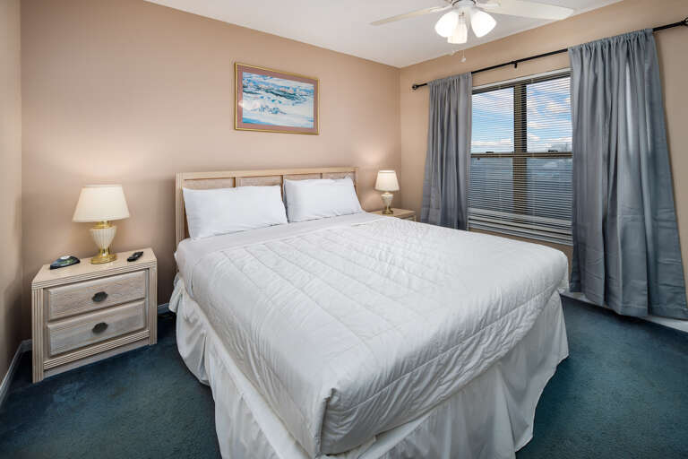 The master bedroom of this condo features a king bed.