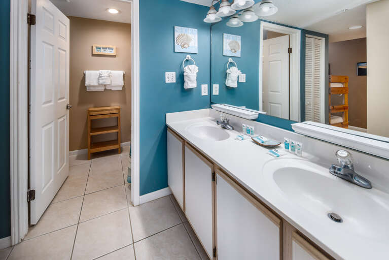 The bathroom has lots of space, unique fixtures and a double sink.