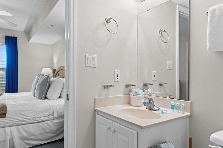 The bathroom has facilities beside the bedroom and the bunk area, with the shower and the washer and  dryer in between them.