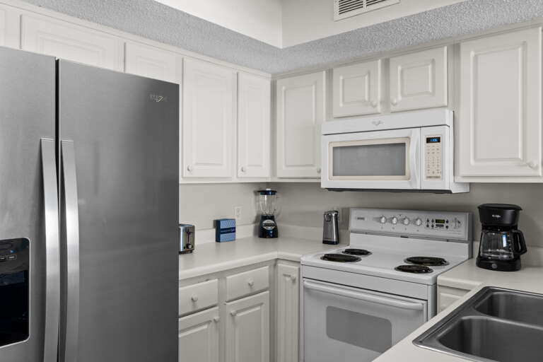 The kitchen has full-size appliances and is stocked with dishes and cooking supplies for all your vacation meal needs.