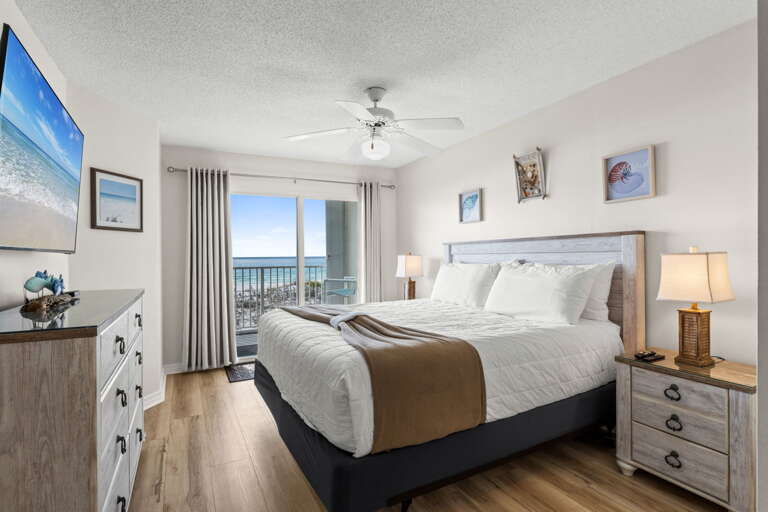 A king-sized retreat with a flat-screen TV and private balcony access for ultimate relaxation.