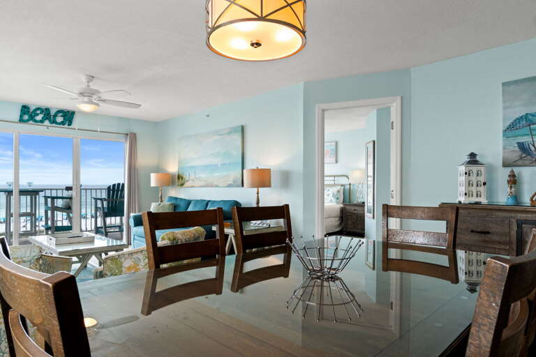 The dining table seats 6 guests and more seating is available at the breakfast bar