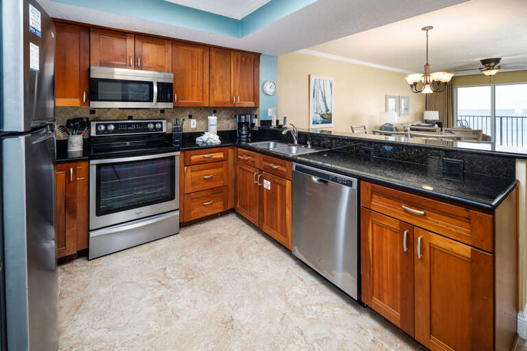 This updated kitchen is fully equipped for all of your cooking needs. Who wouldn't want to prepare a meal alongside our enticing emerald waters! Everything you need is right at your fingertips. Cherry stained cabinets and granite counter tops make up this