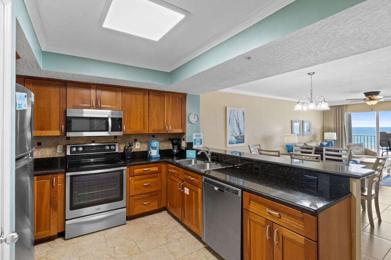 This updated kitchen is fully equipped for all of your cooking needs. Who wouldn't want to prepare a meal alongside our enticing emerald waters! Everything you need is right at your fingertips. Cherry stained cabinets and granite counter tops make up this