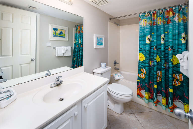 Guest restroom with access from both the hallway and the guest bedroom.