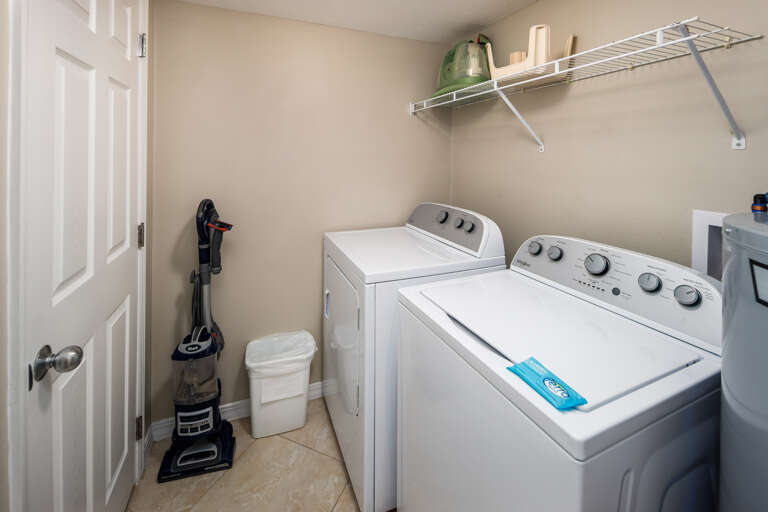 Spacious laundry room with a full size washer and dryer for all your laundry needs. 