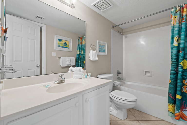 Guest restroom with access from both the hallway and the guest bedroom.