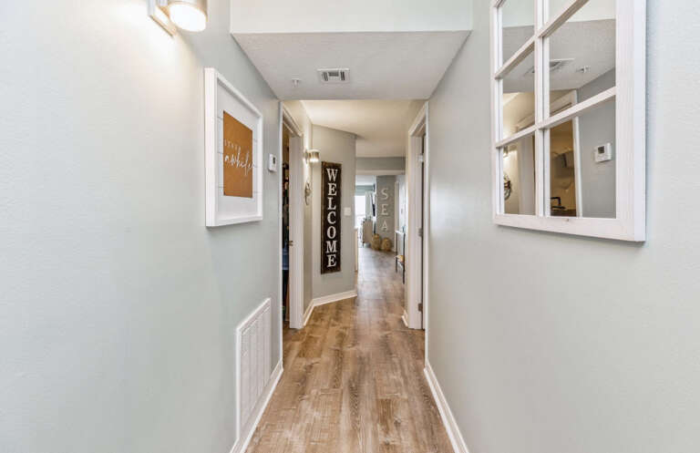 This unit has beautiful beach themed décor throughout it & wood floors. 