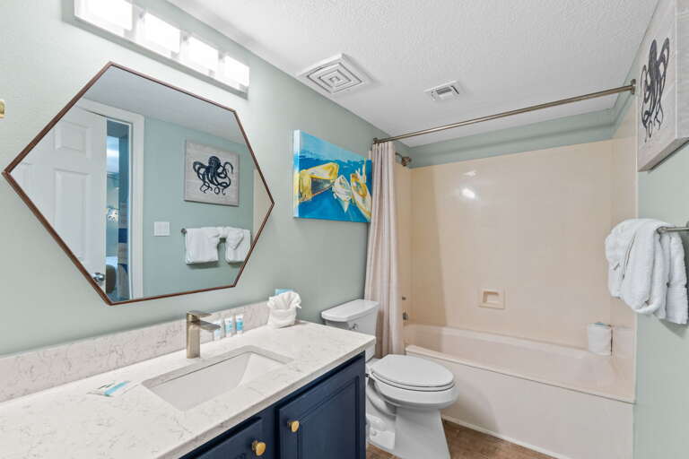 Second bathroom featuring a tub / shower combo as well & lots of counter space.