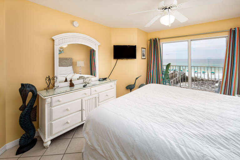 Wall mounted television in this master bedroom keeps the room streamlined and uncluttered