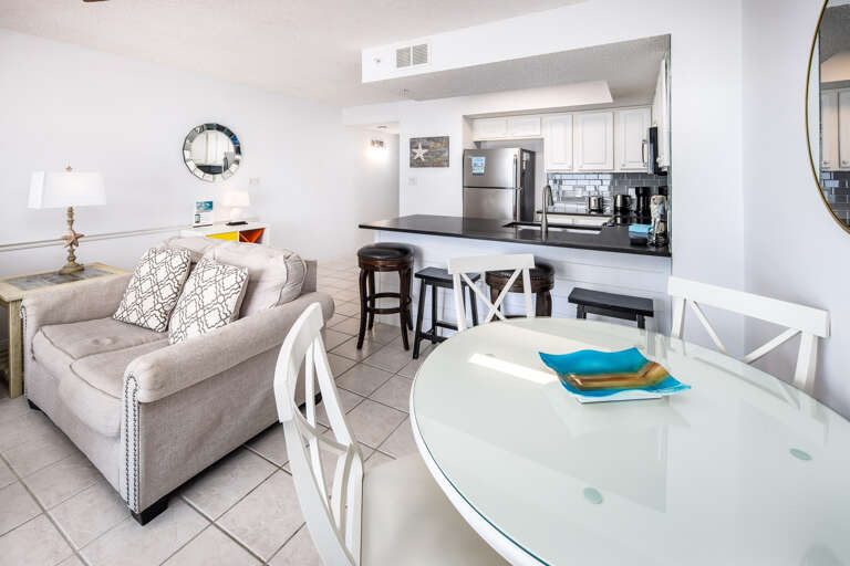 The dining table is close to the kitchen for convenience.  