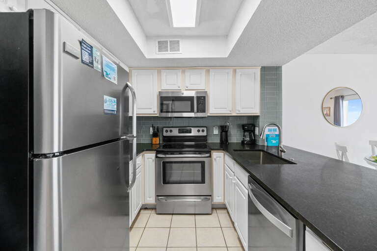 Stainless steel appliances & great lighting makes this kitchen easy to work in. 