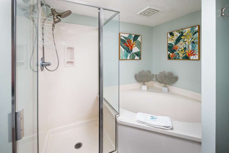A garden tub, separate stall shower, linen storage and separate commode area (not pictured) make up the rest of the large master bath.