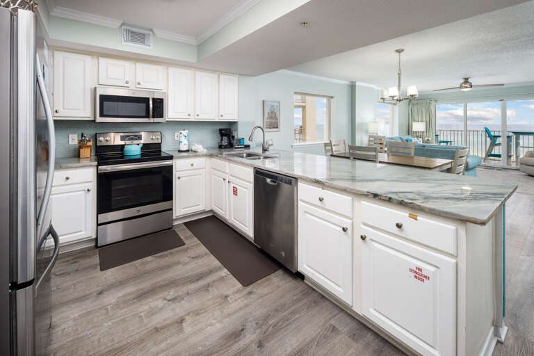 The full kitchen includes a dishwasher and small kitchen electrics such as a coffeemaker, blender and toaster.