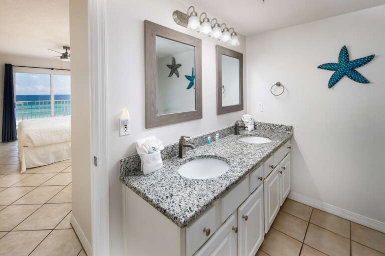 Double Sinks and long mirror are perfect for this delightfully furnished Master Bath. Granite counter top allows plenty of room for the personals.