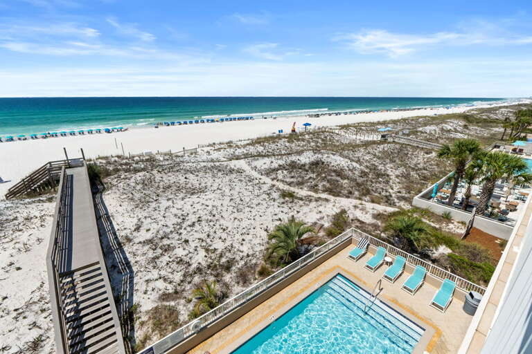 View of the direct access from the building over the sand dunes right to the shore.