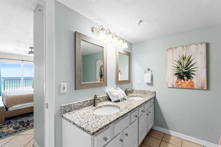 Double Sinks and long mirror are perfect for this delightfully furnished Master Bath.