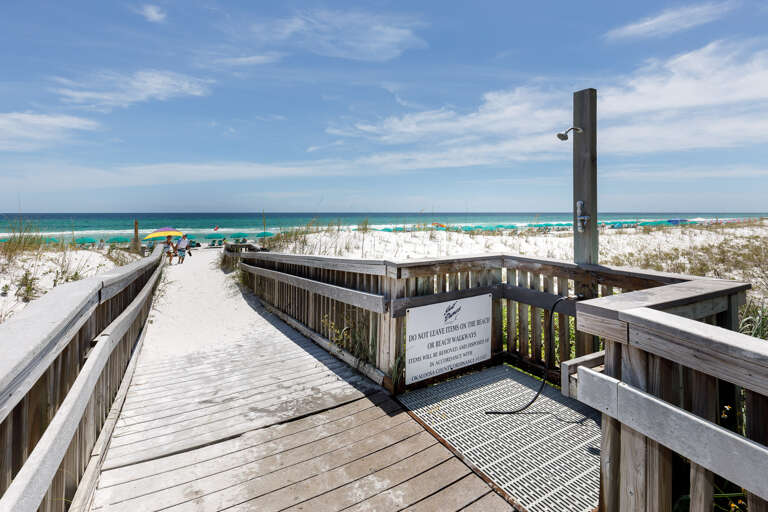 You can rinse the sand off at the beach shower.  You can rinse the sand off at the beach shower.