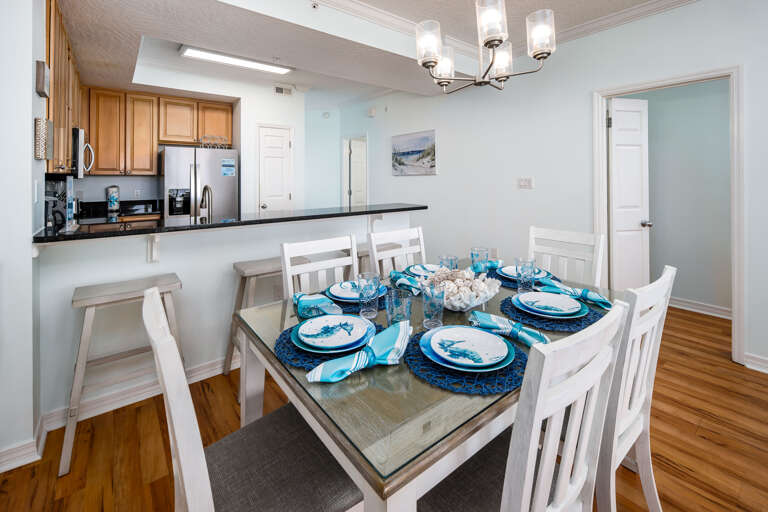 Dining Area: Gather around a stylish table for six, complete with beachy decor and ocean vibes!