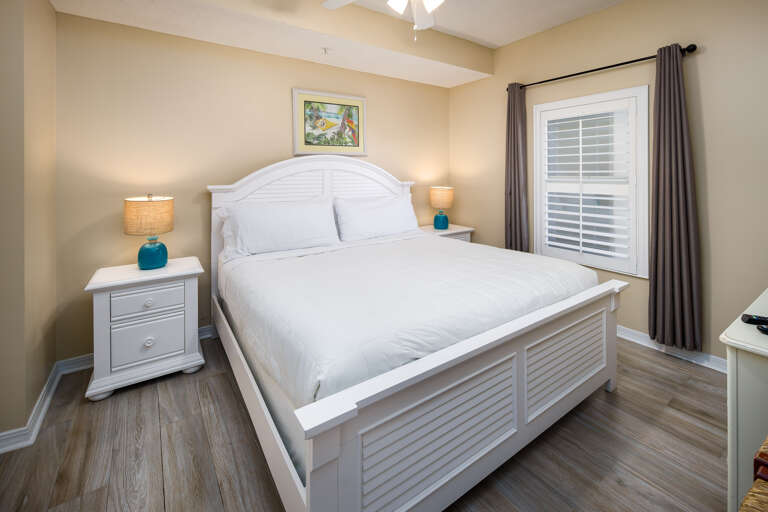 The master bedroom features a king size bed, and also includes a flat screen TV.