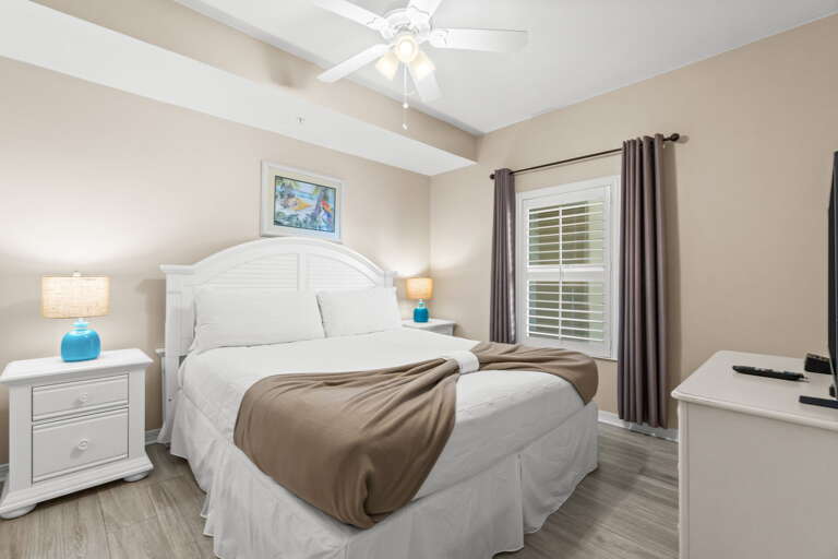 The master bedroom features a king size bed, and also includes a flat screen TV.