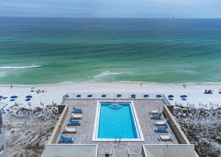 Aerial View, Beach And Azure Pool Between Buildings