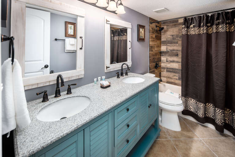 Featuring a double vanity and tub/shower combo.