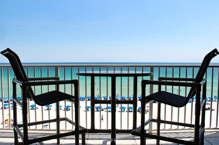 Directly beach front. No obstructions, no streets to cross. Right. On. The. Beach. High top chairs and table. No more looking through the rails!