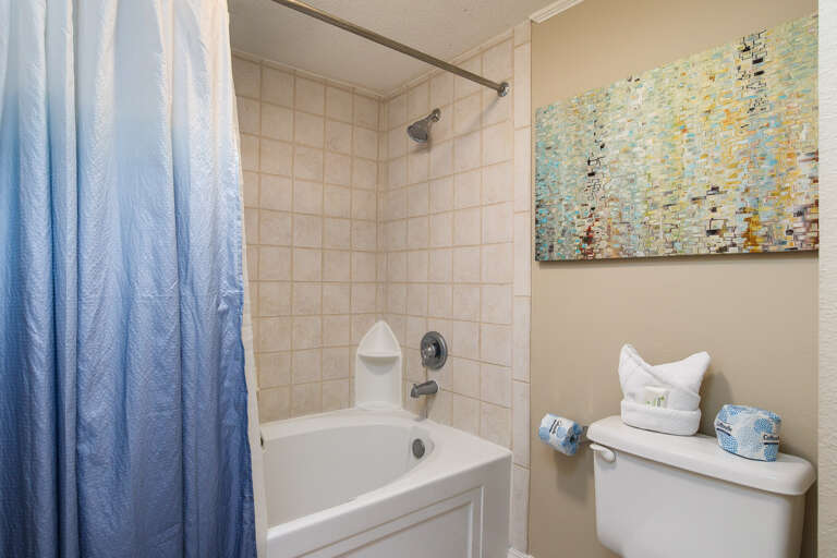 This bathroom is brightly decorated with many of the beachy colors.  