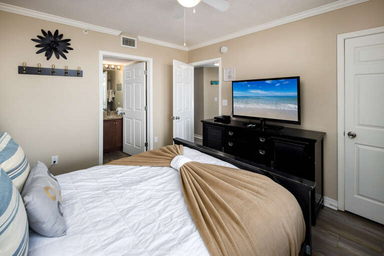 Flat screen TV and the entry to the second full bath.