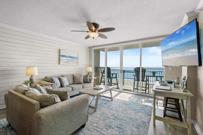 Living Room: Bright and airy space with stunning beach views and comfy furnishings for relaxation