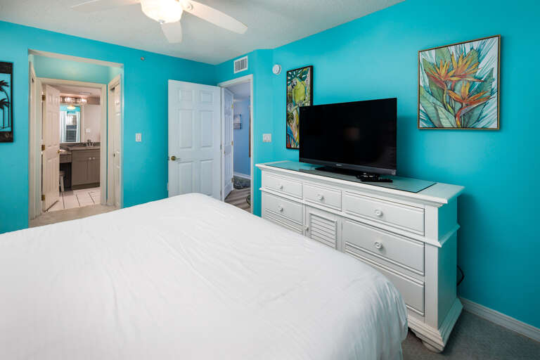 Facing a flat screen TV with a private bathroom to the side 