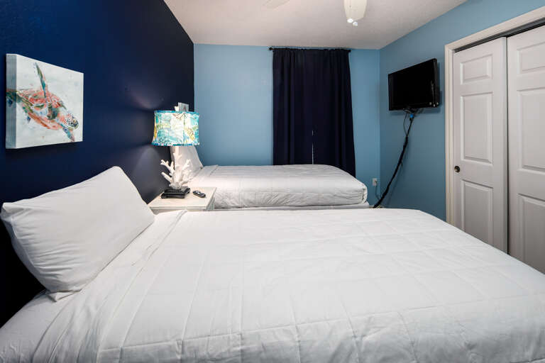 This bedroom has a TV & a window for more sunlight