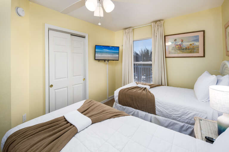 The lovely Guest Room contains a sunny window, TV, and easy access to the guest bathroom.