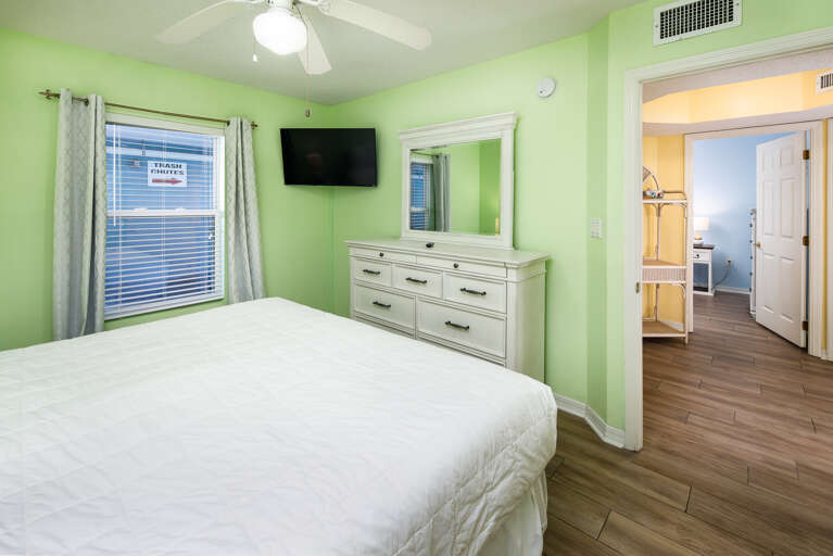 The Master Bedroom has a full en suite bath and a King sized bed facing a mounted TV  The Master Bedroom has a full en suite bath and a King sized bed facing a mounted TV