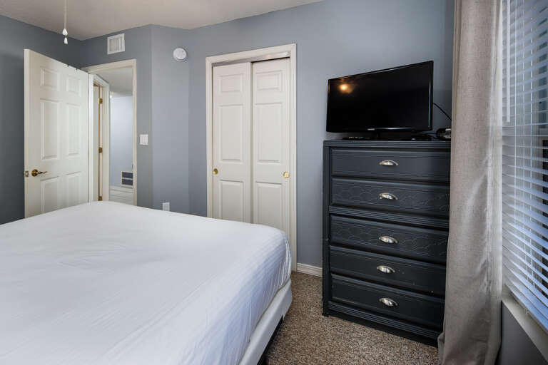 This bedroom has a TV & a window for more sunlight This bedroom has a TV & a window for more sunlight
