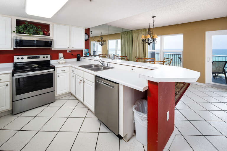 Fully stocked kitchen features all stainless steel appliances.