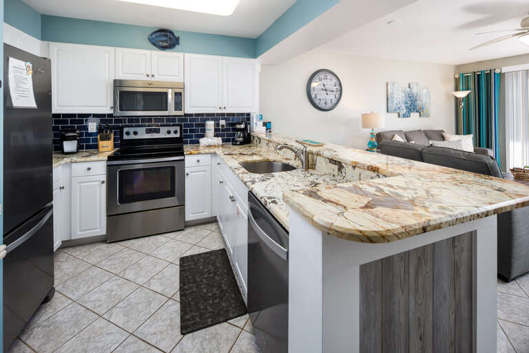 Fully equipped kitchen with stainless steel appliances and beautiful counter tops 