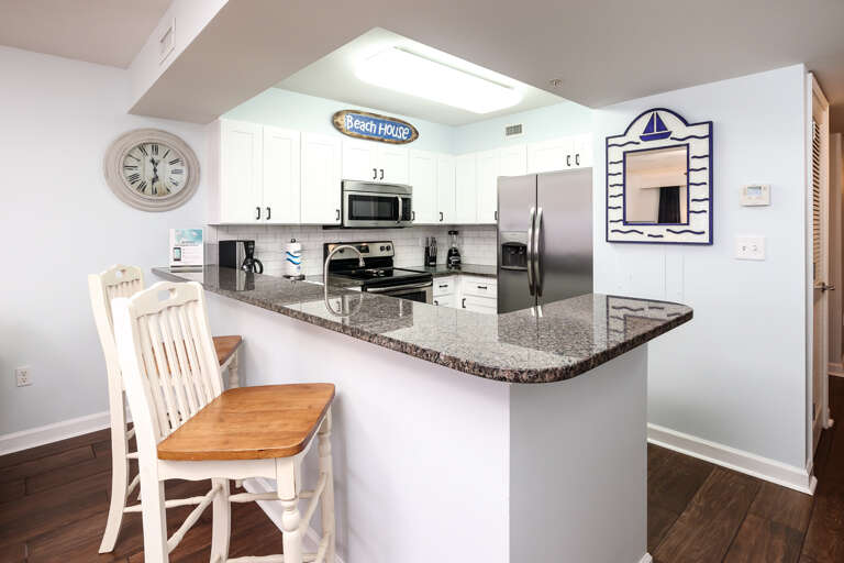 2 bar stools sit at the breakfast bar for a quick bite to eat!