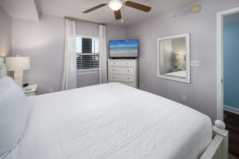 A comfy master bedroom to include a Smart TV.