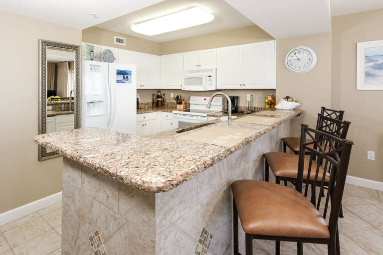 Granite counter tops and decorative tile work make the kitchen look as elegant as it is functional.